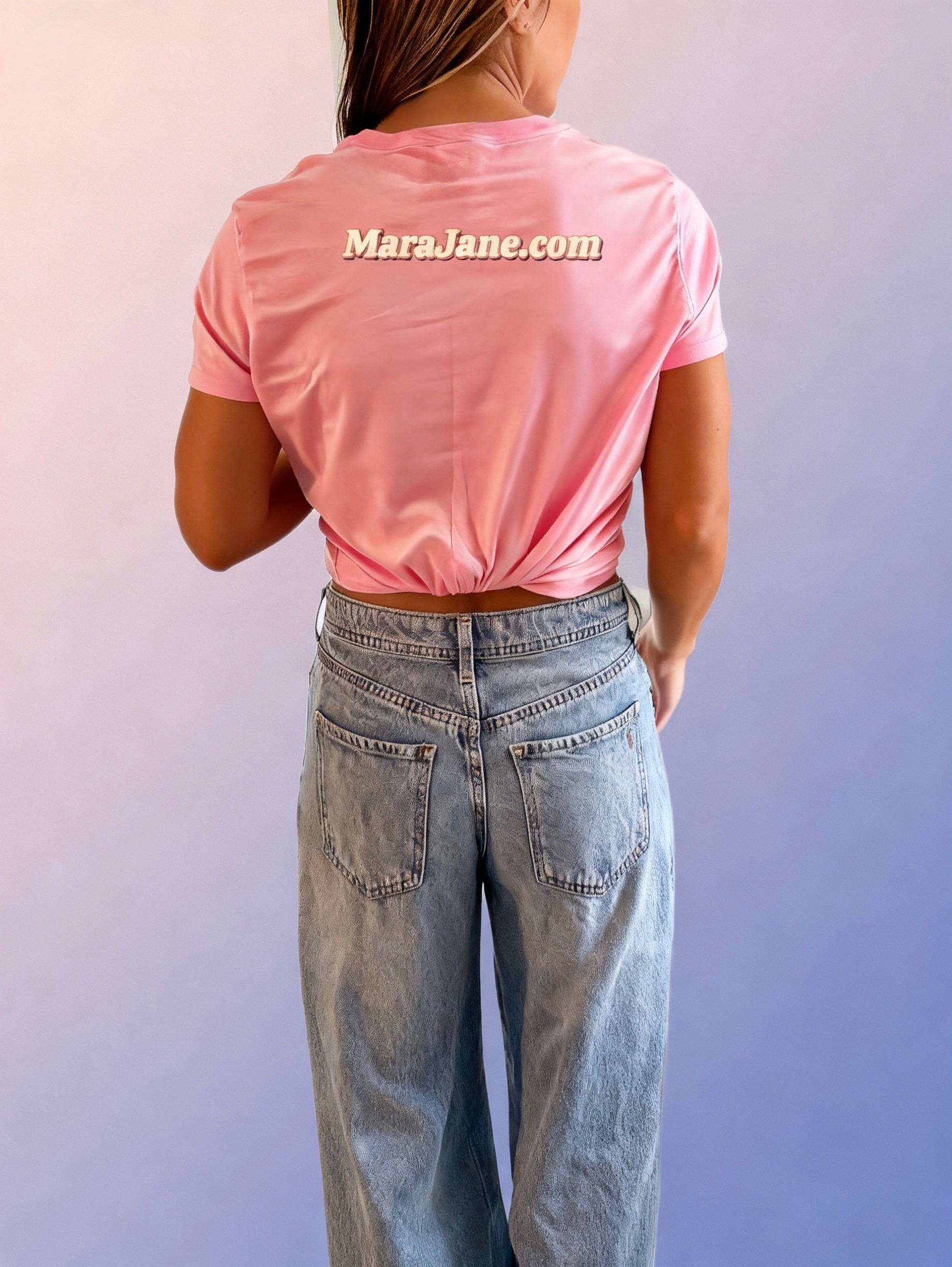 Mara wearing a pink MaraJane.com shirt and jeans, viewed from behind